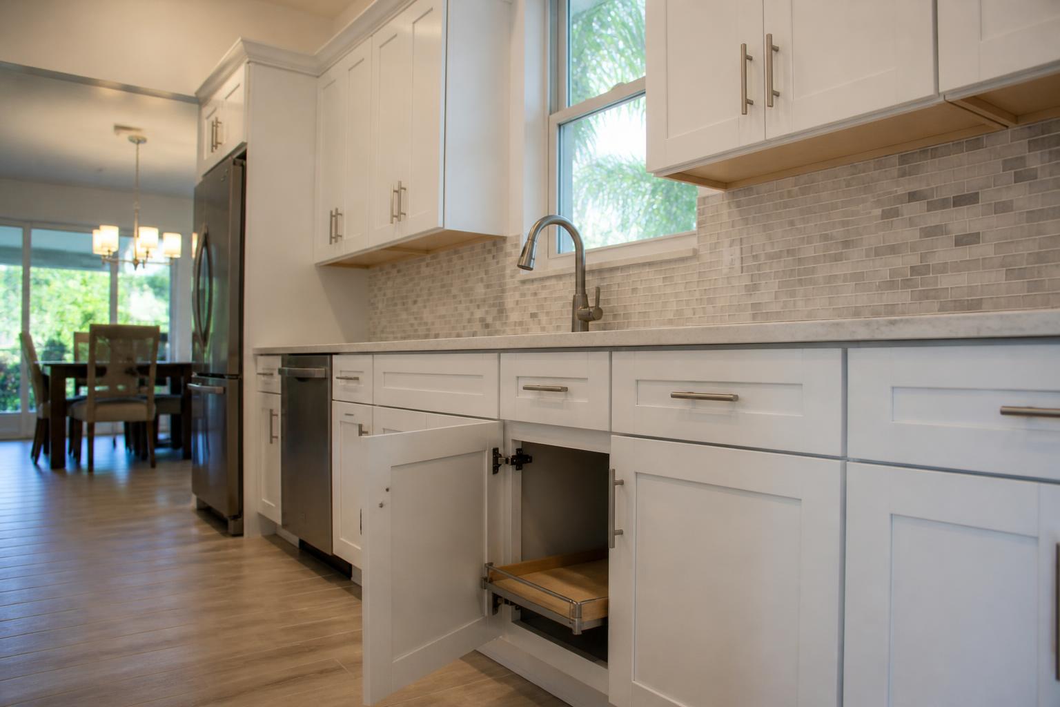 Open refaced base cabinet showing a soft-close hinge and a pull-out shelf
